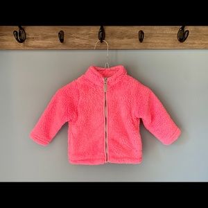 Carter’s bright pink fuzzy Sherpa-like jacket